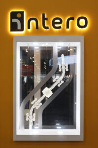 Photo of the Pipe Explorer display case showcasing the 3D printed model and frosted vinyl stickers to simulate the robot being in a pipe